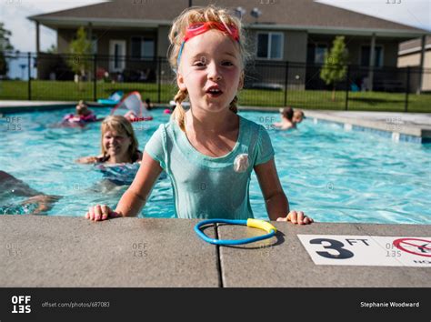 happy  girl standing  swimming pool  hot summers day stock