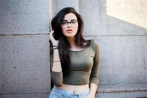 And Pretty Brunette In Glasses Posing On The Streets