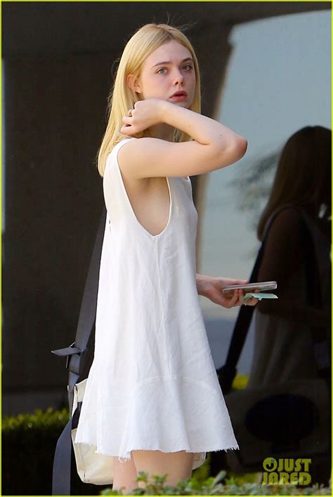 elle fanning shows off tiny waist and shoulders in ruffled crop top