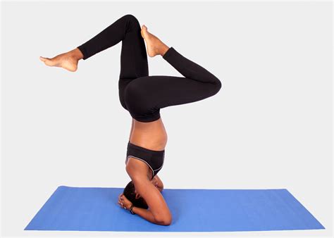 athletic woman  headstand yoga pose