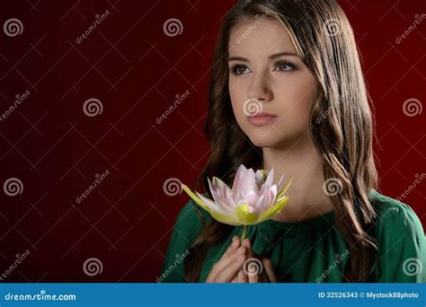 thoughtful teenage girl pretty teenage girl holding  flower  stock