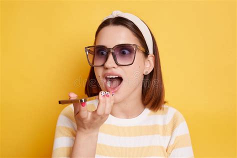 Portrait Of Excited Positive Dark Haired Woman Wearing Striped T Shirt