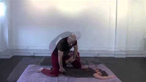 thai massage stretches and compressions with client prone on stomach
