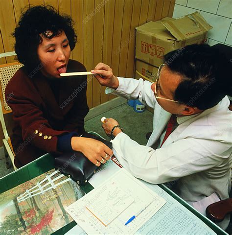 Woman Having Tongue Examination By Chinese Doctor Stock