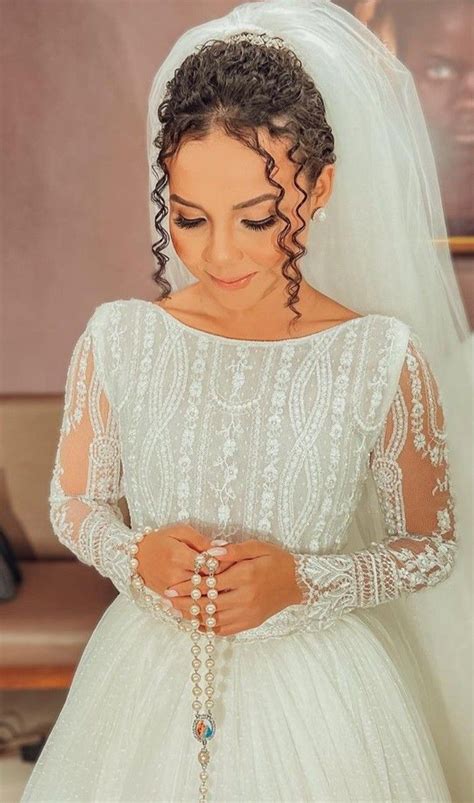 a woman wearing a wedding dress and veil