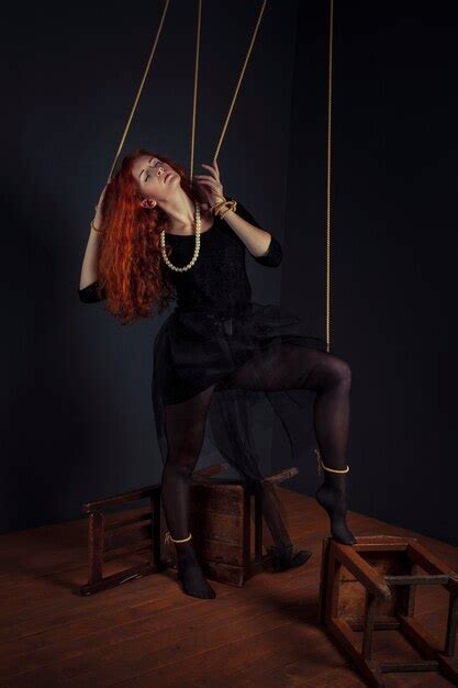 Premium Photo Halloween Redhead Woman Marionette Doll Tied With Ropes