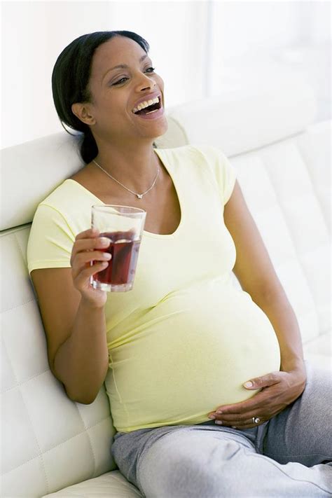 pregnant woman laughing photograph by ian hooton science photo library