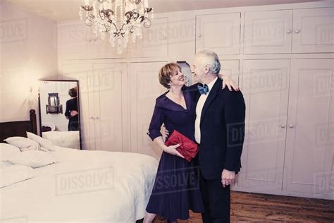 Couple In Bedroom Mature Woman With Arm Around Senior Man Stock