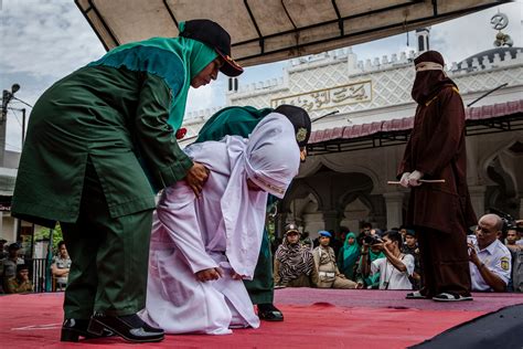 indonesia unmarried couples caned for public affection in an act of