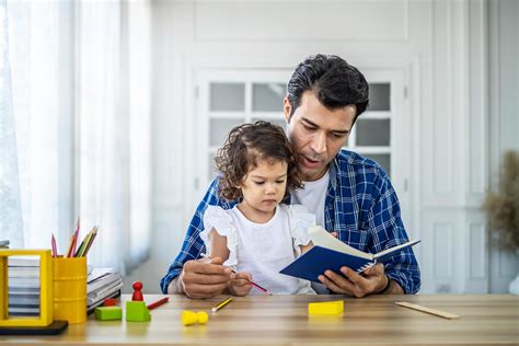 portrait  young father teaching  cute  daughters study excited smiling small child