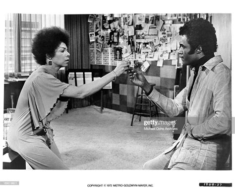 Rosalind Cash Takes A Key From Calvin Lockhart S Hand In A Scene From