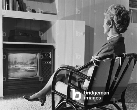 Side Profile Of A Mature Woman Watching Television By