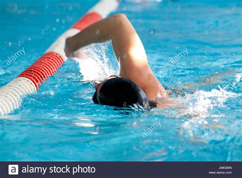 mature woman wearing swimsuit goggles and swimming cap by
