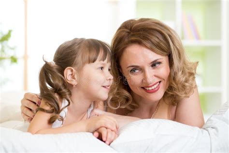 Mom With Daughter Converse Lying On Bed Stock Image Image Of Mother