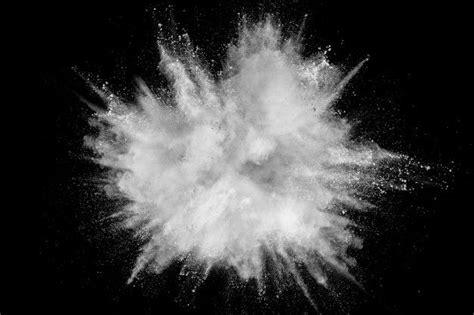 premium photo white powder explosion isolated  black background