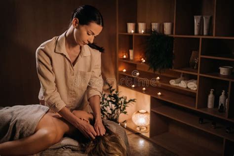 A Masseuse Gives A Body Massage To A Woman In A Spa Center A