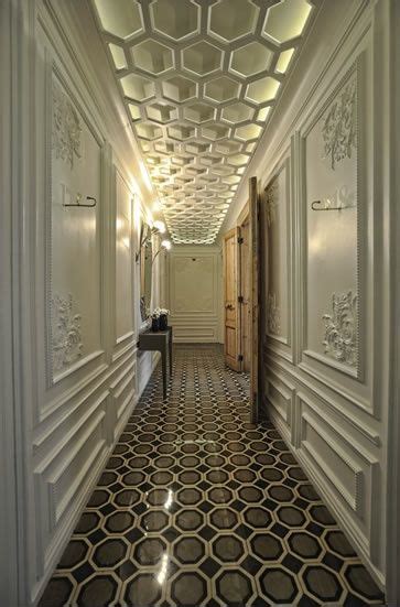 long hallway  white walls  black floor tiles   wall