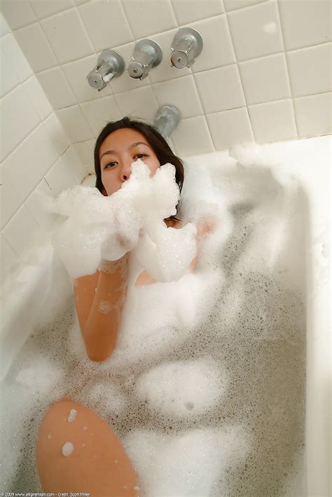 skinny asian amateur starlingz poses nude while blowing bubbles in shower