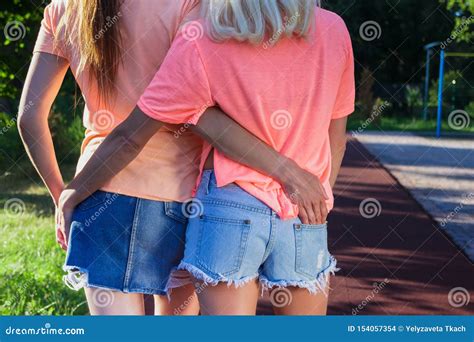 Two Beautiful Girls Hug Each Other Outdoors Blurred Background Stock