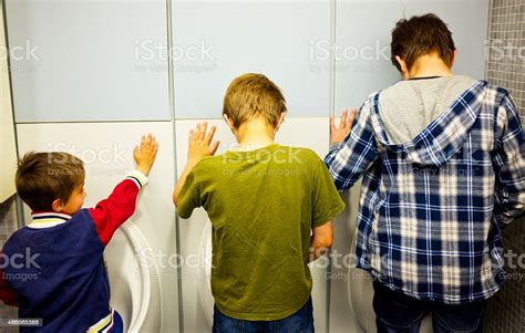 Three Siblings In Decreasing Scale Pissing Public Urinals From Behind