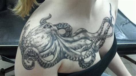 A Black And White Tattoo Of An Octopus Adorns This Girls