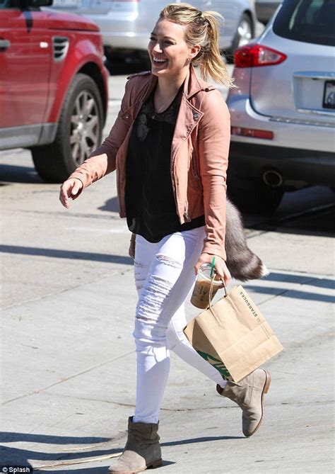 hilary duff shows off her toned legs in ripped skinny