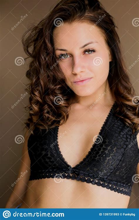 Beautiful Brown Haired Girl Looking At Camera At Home Stock Image