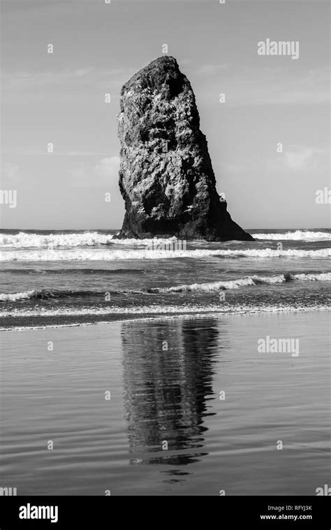 Waves Crashing On Vertical Rocks Protruding In Cannon Beach Oregon