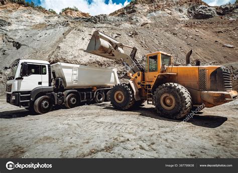 wheel loader loading gravel sand dumper trucks machinery transportation