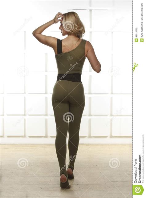beautiful blonde with perfect athletic slim figure engaged in yoga pilates exercise or fitness