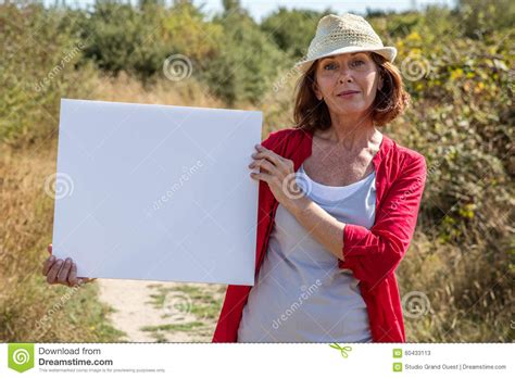 gorgeous mature woman smiling showing her search on sign outdoors stock image image of insert