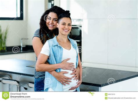 portrait of pregnant lesbian couple embracing stock image image of enjoyment embracing 66973313