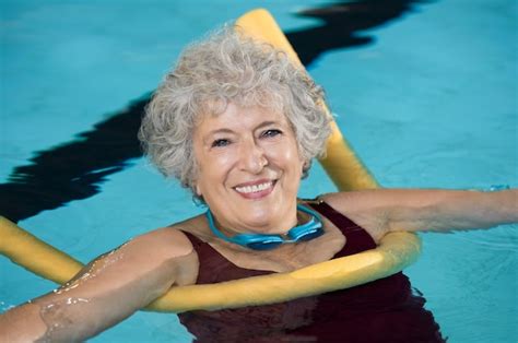 Premium Photo Senior Woman Doing Aqua Fitness With Swim Noodles