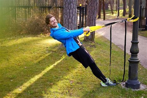 Free Photo Man Fitness Model In A Blue Sport Jacket Doing Workouts