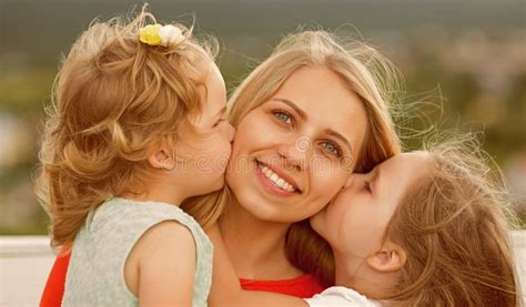 daughters kiss mother on natural landscape stock image image of bench