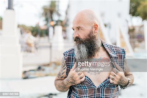Mature Male Hipster Revealing Tattooed Chest Photo Getty Images