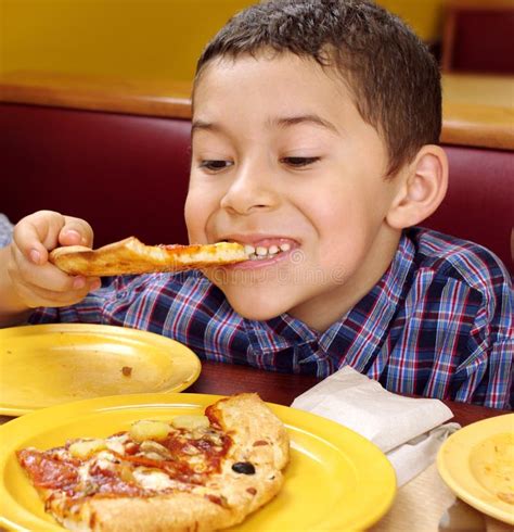boy eating  pizza stock photo image  dining child