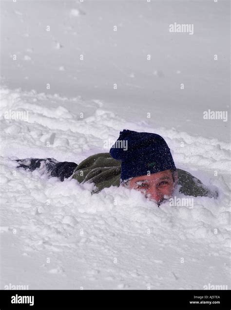 man buried  snow stock photo  alamy