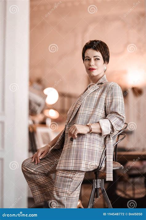 Stylish Short Haired Brunette Woman In Elegant Business Plaid Pantsuit