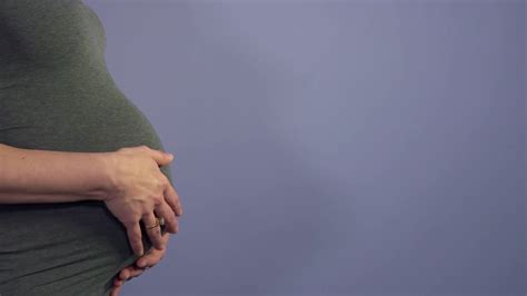 Pregnant Woman Showing Belly And Female Hands Touching It Mom With