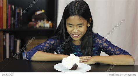 Asian Girl Enjoys Whip Cream On Birthday Cupcake 영상 소스 2423007
