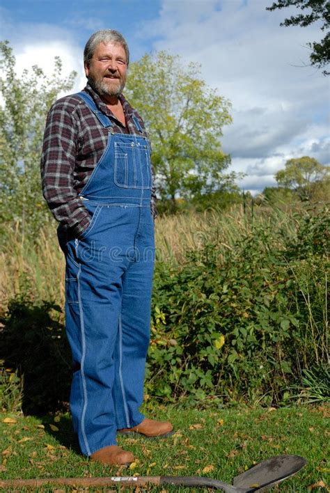 farmer grey haired bearded farmer wearing bib overalls pantalones