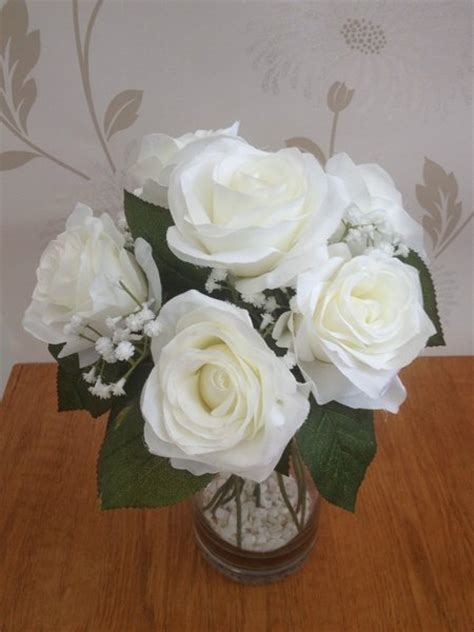 silk ice white rose and gypsophila flower arrangement in glass vase with