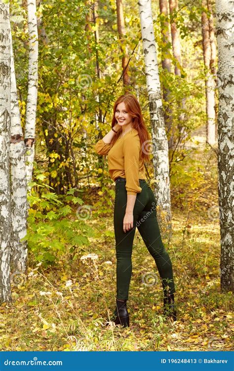 Portrait Of A Beautiful Redhead Woman In Autumn Forest Stock Image