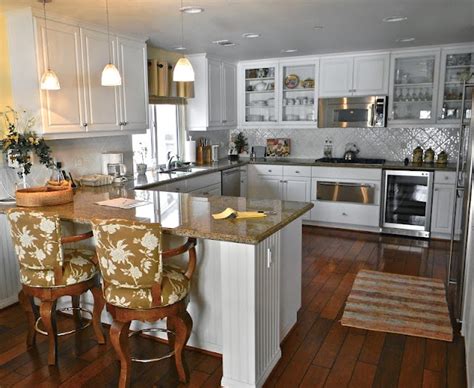 island  peninsula  kitchen layout serves   designed