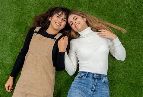 top view of two stylish girl friends having fun laughing and making