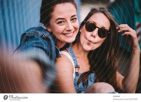 two happy girlfriends taking selfie together a royalty free stock
