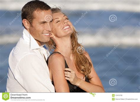 Couple Laughing In Romantic Embrace On Beach Royalty Free