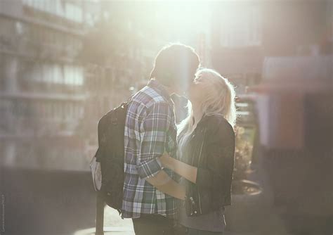 Teenage Couple Kissing On The Street By Stocksy Contributor Lumina