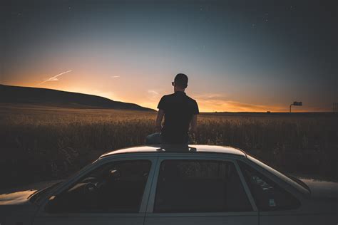 boy sitting  top  car watching nature view  hd photography